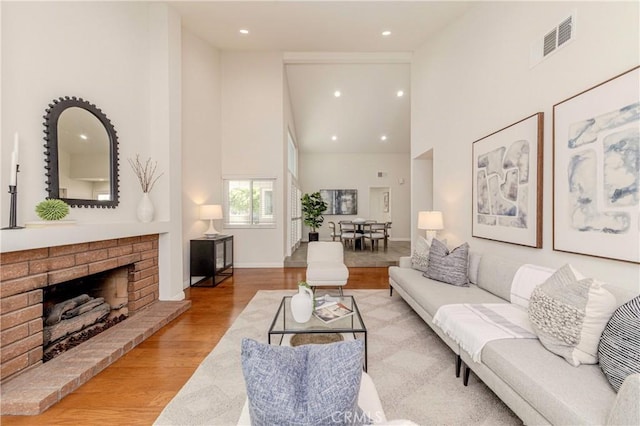 868 Ethelinda Way, Brea, CA 92821 - living room with high vaulted ceiling, wood finished floors, recessed lighting, and a brick fireplace
