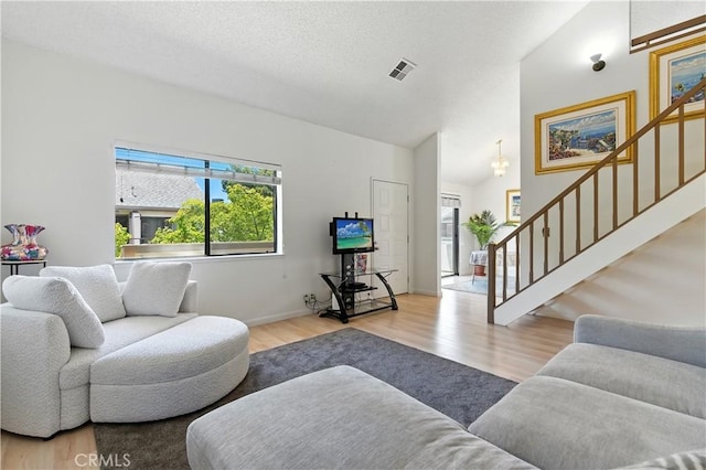39239 Walnut Ter, Fremont, CA 94536 - living area featuring wood finished floors, stairway, and vaulted ceiling