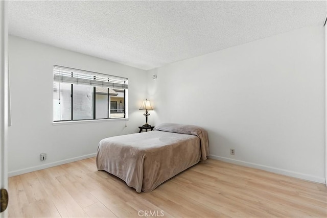 39239 Walnut Ter, Fremont, CA 94536 - bedroom featuring light wood-style flooring and a textured ceiling