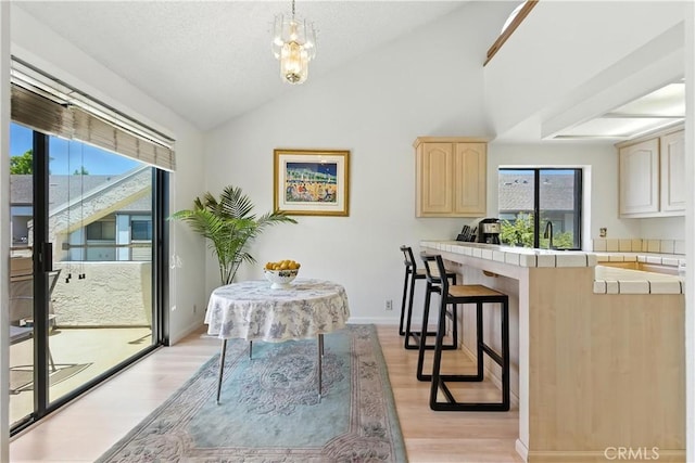 39239 Walnut Ter, Fremont, CA 94536 - dining room with vaulted ceiling, light wood finished floors, and a chandelier