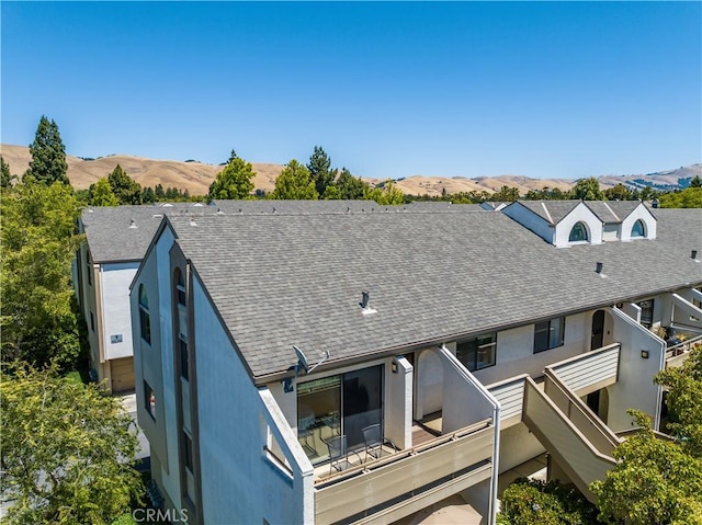 39239 Walnut Ter, Fremont, CA 94536 - back of house featuring stucco siding, roof with shingles, a mountain view, and a balcony