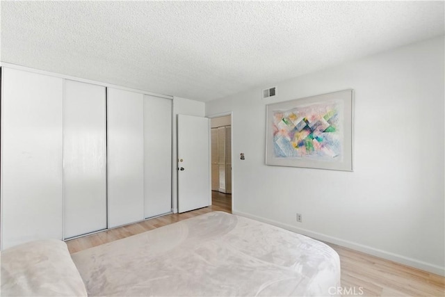 39239 Walnut Ter, Fremont, CA 94536 - bedroom with wood finished floors, a closet, and a textured ceiling