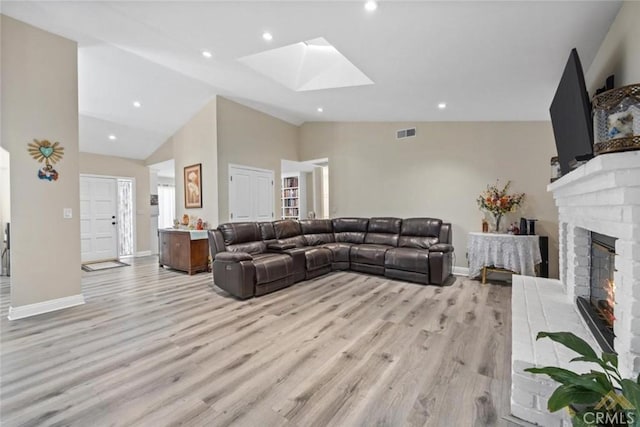 3105 Whisper Oak Way, Bakersfield, CA 93311 - living area with lofted ceiling, a skylight, light wood-style flooring, a fireplace, and recessed lighting