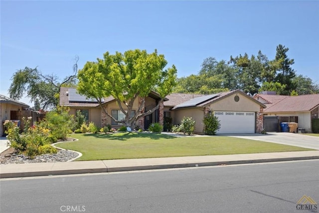 3105 Whisper Oak Way, Bakersfield, CA 93311 - view of front of house featuring roof mounted solar panels, a garage, and stucco siding