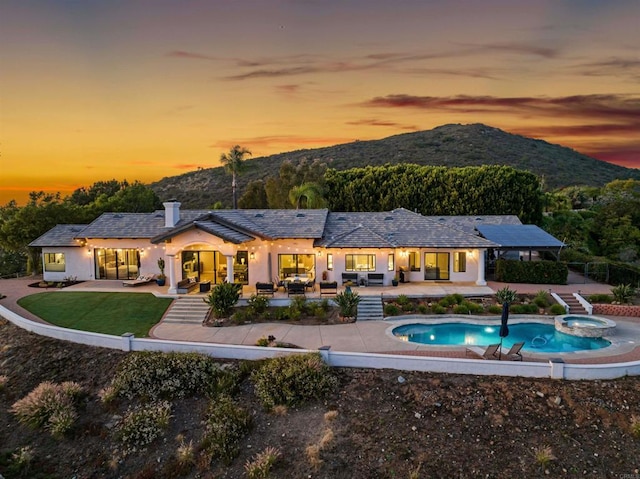 1966 Las Lomas, Vista, CA 92084 - rear view of house featuring a patio area, a mountain view, stucco siding, a pool with connected hot tub, and outdoor lounge area