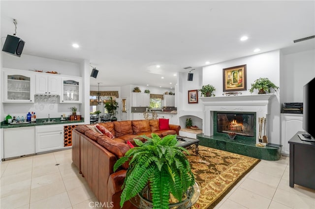 43110 Palomino Cir, Temecula, CA 92590 - living room featuring a glass covered fireplace, light tile patterned flooring, recessed lighting, and wet bar
