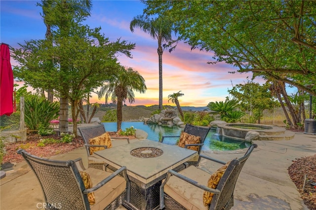 43110 Palomino Cir, Temecula, CA 92590 - patio terrace at dusk with a patio area and a pool with connected hot tub