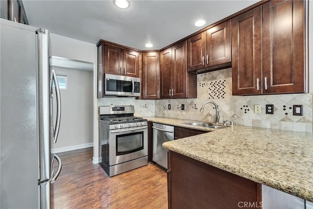 960 Golden Springs Dr Unit G, Diamond Bar, CA 91765 - kitchen featuring stainless steel appliances, light wood finished floors, dark brown cabinetry, light stone countertops, and tasteful backsplash