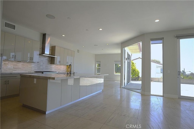 2615 Temple Hills Dr, Laguna Beach, CA 92651 - kitchen featuring wall chimney range hood, decorative backsplash, a kitchen island with sink, light countertops, and recessed lighting
