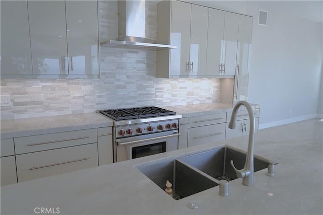 2615 Temple Hills Dr, Laguna Beach, CA 92651 - kitchen with wall chimney range hood, stainless steel stove, modern cabinets, white cabinets, and decorative backsplash