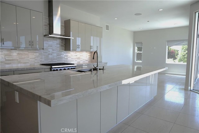 2615 Temple Hills Dr, Laguna Beach, CA 92651 - kitchen with wall chimney exhaust hood, modern cabinets, tasteful backsplash, light tile patterned floors, and recessed lighting