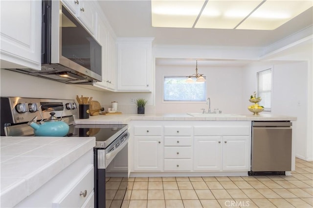 2217 E Brower St, Simi Valley, CA 93065 - kitchen with appliances with stainless steel finishes, tile counters, white cabinetry, and healthy amount of natural light
