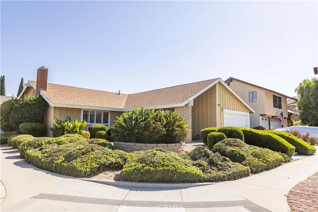 2217 E Brower St, Simi Valley, CA 93065 - view of front of home with an attached garage, a chimney, board and batten siding, and a shingled roof