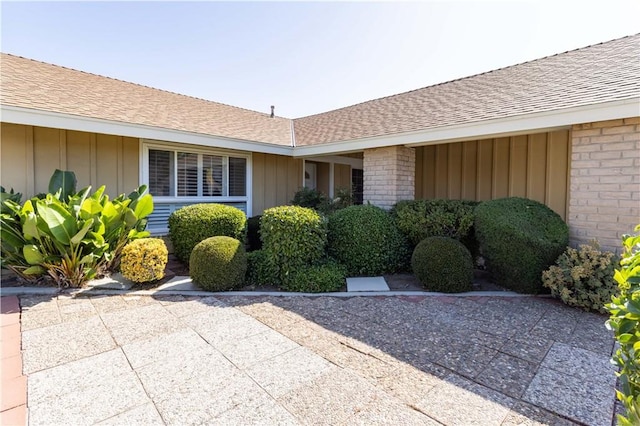 2217 E Brower St, Simi Valley, CA 93065 - entrance to property featuring board and batten siding, roof with shingles, and brick siding