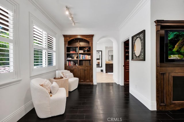 5329 Shirley Ave, Tarzana, CA 91356 - sitting room featuring arched walkways, crown molding, dark wood finished floors, and track lighting