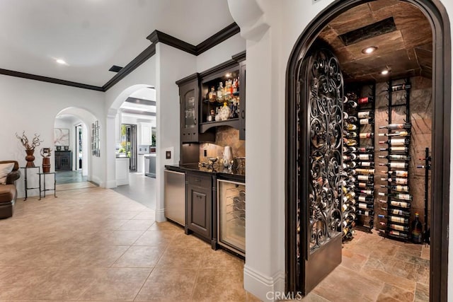 5329 Shirley Ave, Tarzana, CA 91356 - wine cellar featuring arched walkways, crown molding, electric panel, wine cooler, and bar