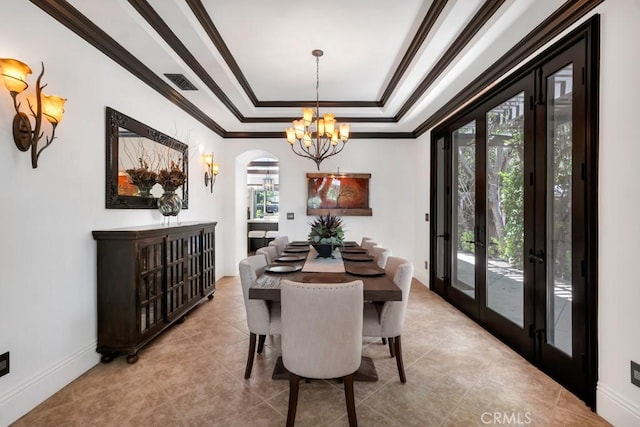 5329 Shirley Ave, Tarzana, CA 91356 - dining room featuring crown molding, a raised ceiling, a chandelier, arched walkways, and tile patterned floors