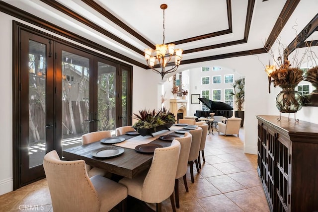 5329 Shirley Ave, Tarzana, CA 91356 - dining area featuring a raised ceiling, a chandelier, light tile patterned floors, and crown molding