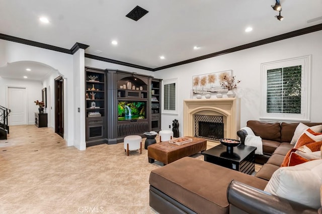 5329 Shirley Ave, Tarzana, CA 91356 - living room with arched walkways, ornamental molding, recessed lighting, a fireplace, and light tile patterned floors