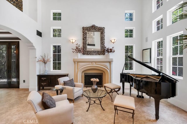 5329 Shirley Ave, Tarzana, CA 91356 - sitting room featuring a high ceiling, arched walkways, a fireplace, healthy amount of natural light, and tile patterned floors