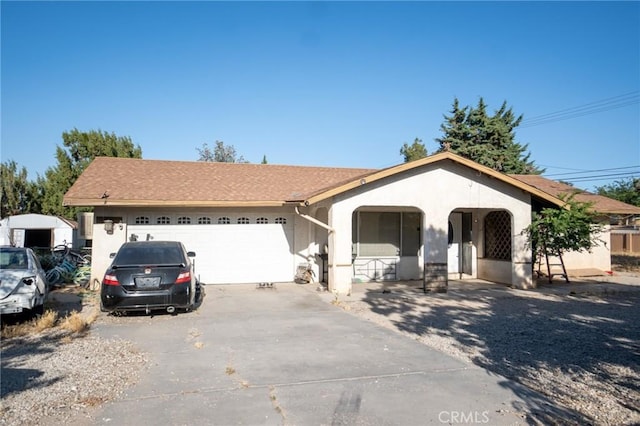 7323 Oakwood Ave, Hesperia, CA 92345 - ranch-style home featuring concrete driveway, a garage, a porch, and stucco siding