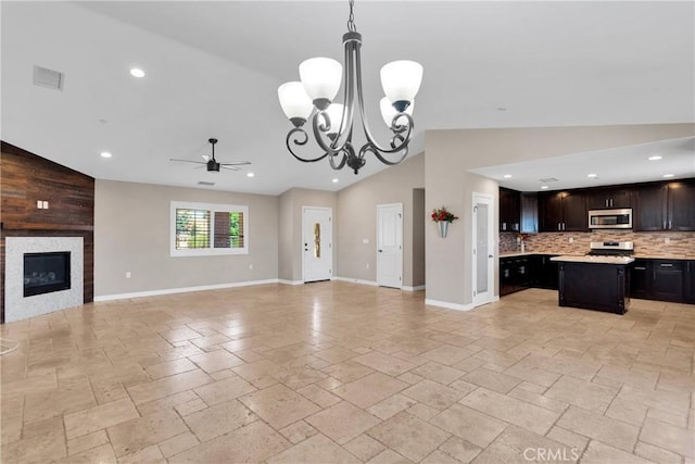 8383 Buckthorn Ave, Hesperia, CA 92345 - unfurnished living room with lofted ceiling, a ceiling fan, a chandelier, stone tile flooring, and recessed lighting