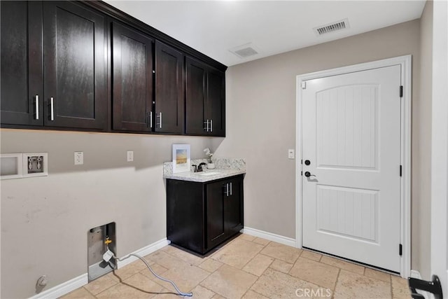 8383 Buckthorn Ave, Hesperia, CA 92345 - laundry area featuring hookup for a washing machine, cabinet space, and stone tile flooring
