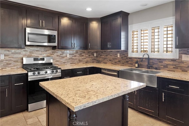 8383 Buckthorn Ave, Hesperia, CA 92345 - kitchen with appliances with stainless steel finishes, a center island, tasteful backsplash, light stone counters, and recessed lighting