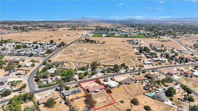 8383 Buckthorn Ave, Hesperia, CA 92345 - aerial view of property and surrounding area with property parcel outlined and a mountain backdrop
