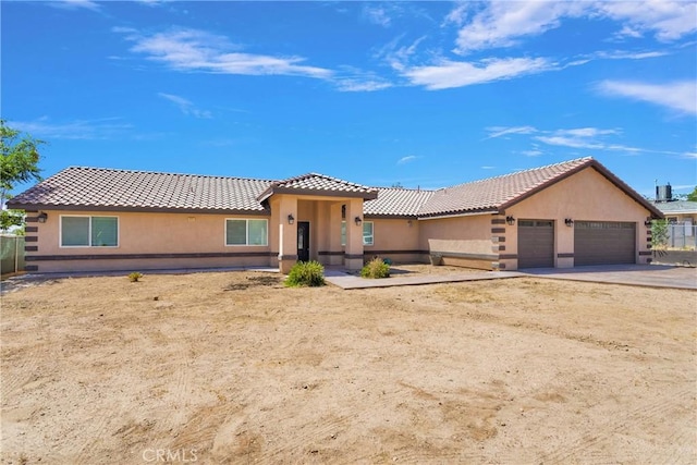 8383 Buckthorn Ave, Hesperia, CA 92345 - view of front facade with a tile roof, stucco siding, an attached garage, and concrete driveway