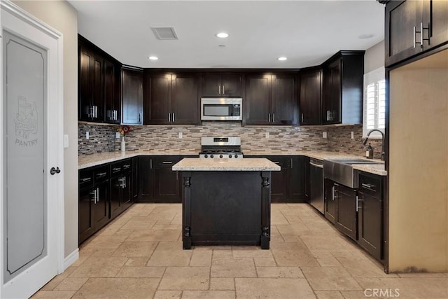 8383 Buckthorn Ave, Hesperia, CA 92345 - kitchen featuring stainless steel appliances, stone tile flooring, decorative backsplash, recessed lighting, and light stone counters