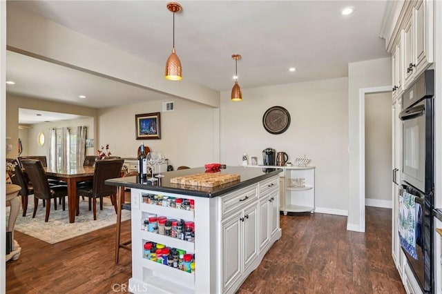 481 S Cedar Dr, Covina, CA 91723 - kitchen with dark countertops, dark wood-style flooring, white cabinets, and recessed lighting