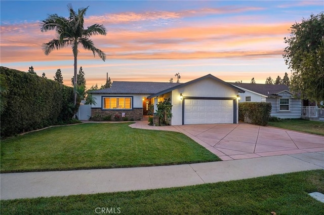 481 S Cedar Dr, Covina, CA 91723 - view of front facade featuring concrete driveway, an attached garage, a front lawn, stucco siding, and stone siding