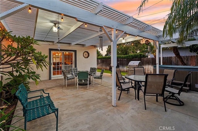 481 S Cedar Dr, Covina, CA 91723 - patio terrace at dusk featuring outdoor dining space, a fenced backyard, a hot tub, and a pergola