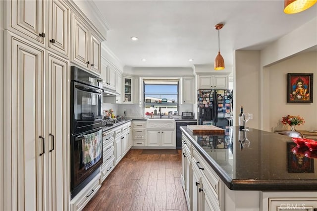 481 S Cedar Dr, Covina, CA 91723 - kitchen featuring black appliances, dark wood finished floors, recessed lighting, pendant lighting, and a kitchen island