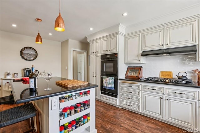 481 S Cedar Dr, Covina, CA 91723 - kitchen with dark countertops, gas stovetop, a breakfast bar, hanging light fixtures, and decorative backsplash