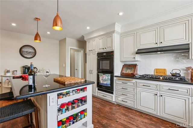 481 S Cedar Dr, Covina, CA 91723 - kitchen featuring dark countertops, stainless steel gas cooktop, a kitchen breakfast bar, hanging light fixtures, and tasteful backsplash