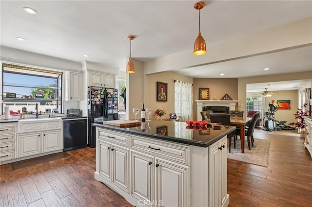 481 S Cedar Dr, Covina, CA 91723 - kitchen with black appliances, a fireplace, ceiling fan, dark wood-style flooring, and pendant lighting