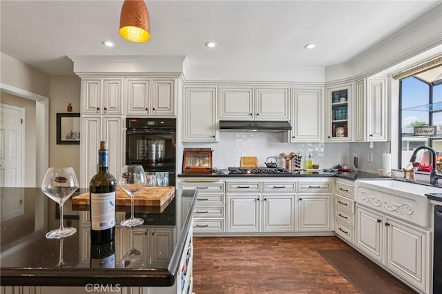 481 S Cedar Dr, Covina, CA 91723 - kitchen featuring dark wood-style floors, decorative backsplash, glass insert cabinets, under cabinet range hood, and dishwasher