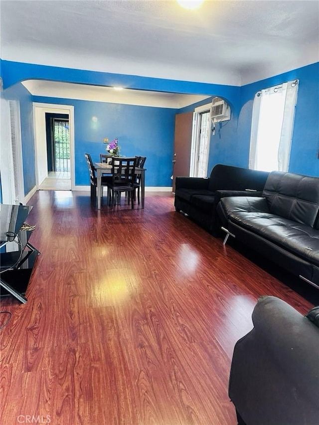 418 W 103rd St, Los Angeles, CA 90003 - living area featuring wood finished floors and arched walkways
