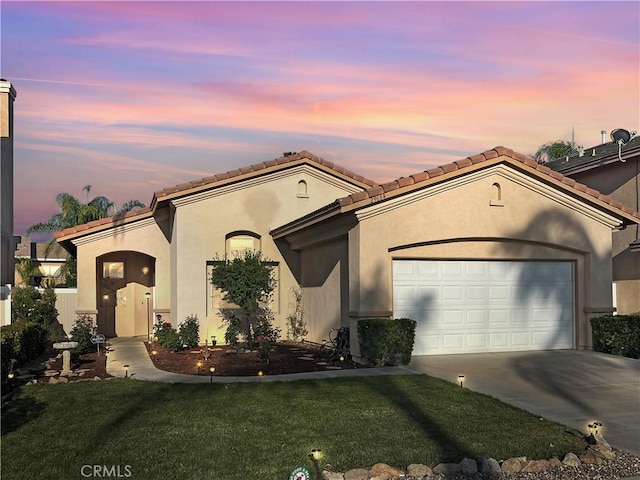 29684 Desert Terrace Dr, Menifee, CA 92584 - mediterranean / spanish-style home with concrete driveway, an attached garage, a lawn, stucco siding, and a tile roof