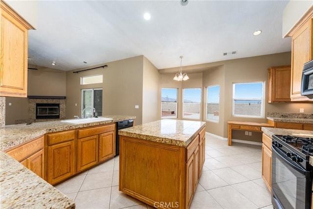 13212 Primavera Rd, Pinon Hills, CA 92372 - kitchen with black appliances, light countertops, a chandelier, light tile patterned flooring, and a kitchen island