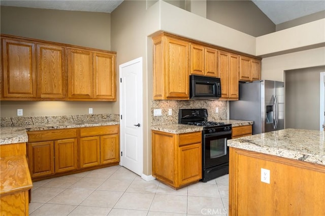 13212 Primavera Rd, Pinon Hills, CA 92372 - kitchen with black appliances, tasteful backsplash, light tile patterned flooring, brown cabinetry, and high vaulted ceiling