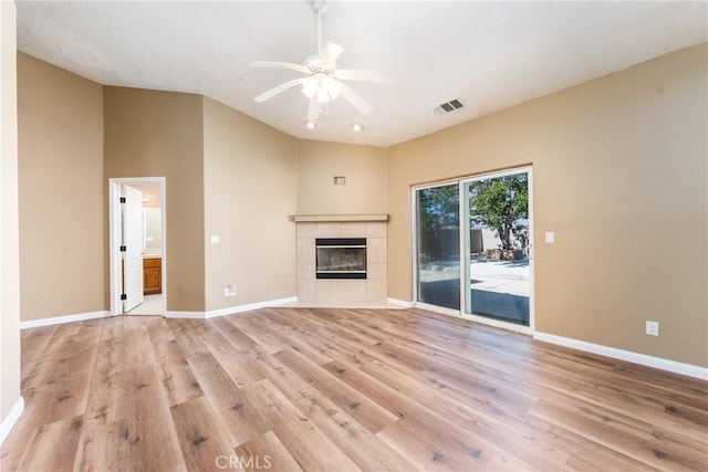 13212 Primavera Rd, Pinon Hills, CA 92372 - unfurnished living room featuring light wood-style flooring, ceiling fan, a fireplace, and vaulted ceiling