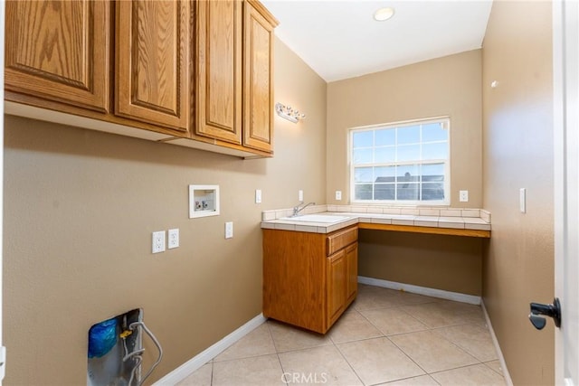 13212 Primavera Rd, Pinon Hills, CA 92372 - washroom with washer hookup, cabinet space, light tile patterned floors, and a desk