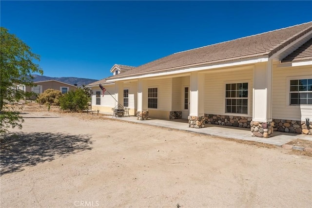13212 Primavera Rd, Pinon Hills, CA 92372 - back of property featuring stone siding and a tiled roof