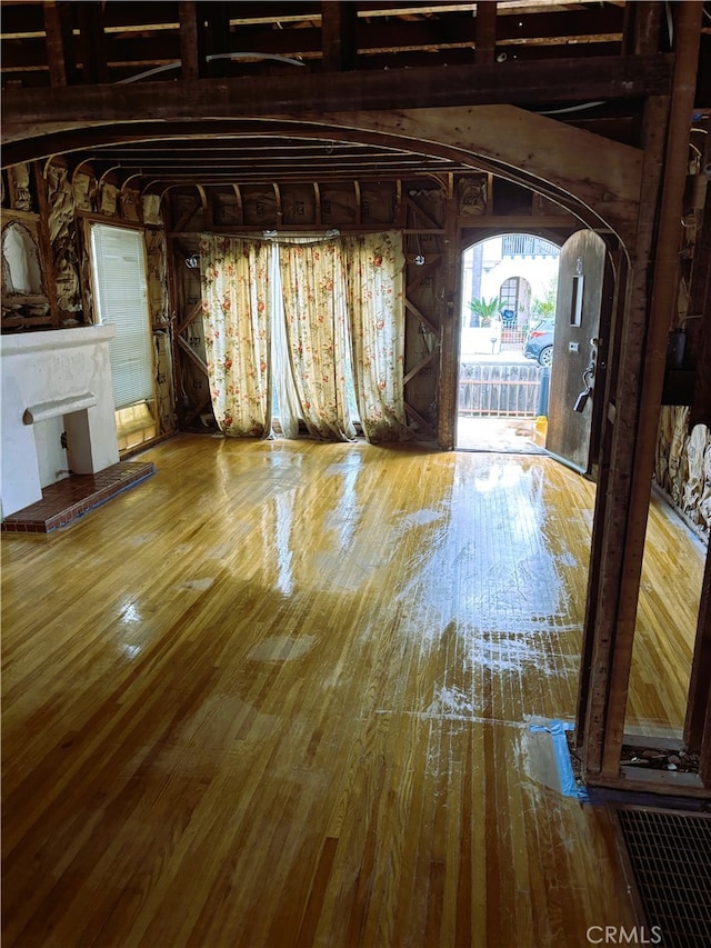 70 Saint Joseph Ave, Long Beach, CA 90803 - unfurnished living room with hardwood / wood-style flooring and arched walkways