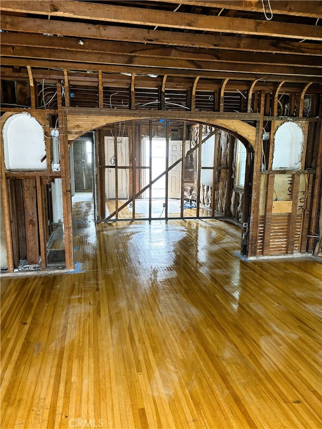 70 Saint Joseph Ave, Long Beach, CA 90803 - unfurnished living room featuring arched walkways and hardwood / wood-style floors