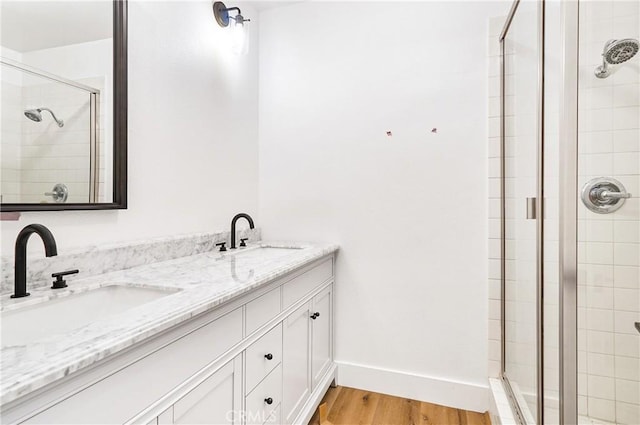 33621 Blue Lantern St, Dana Point, CA 92629 - bathroom featuring a shower stall, double vanity, and wood finished floors