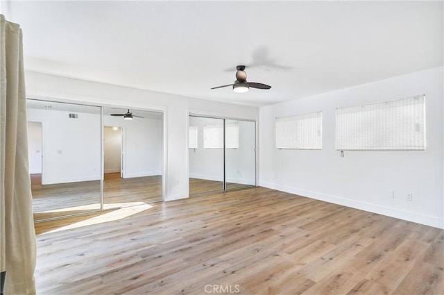 33621 Blue Lantern St, Dana Point, CA 92629 - unfurnished bedroom featuring multiple closets, wood finished floors, and a ceiling fan